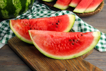 Slices of ripe watermelon on wooden table close up