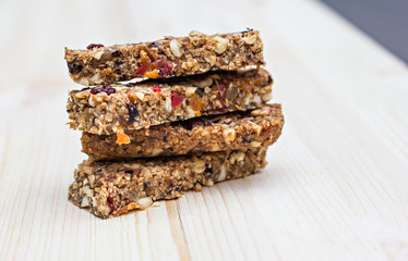 Homemade rustic granola bars with dried fruits and handmade packaged  on wooden background