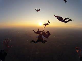 Skydiving group of people at the sunset