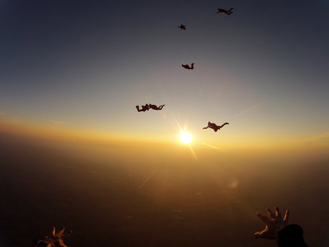 Skydivers at the sunset