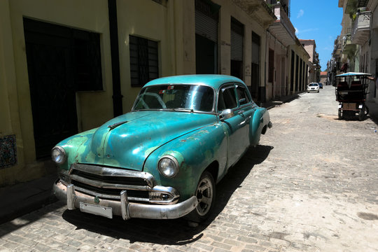 Green vintage car in Old Havana street