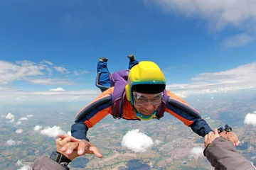 Tuinposter Skydiver senior man, smiling in free fall © Mauricio G