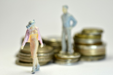 Miniature people with coins