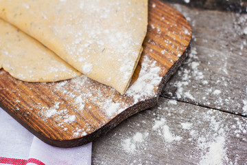 Homemade spaghetti, pasta or noodles on wooden table. Preparation