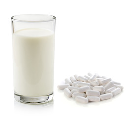 pill and glass of milk isolated on white background