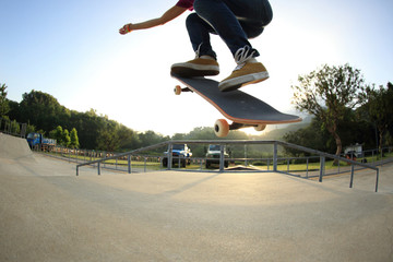 young woman skateboarder skateboarding at skatepark