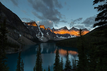 Valley of the Ten Peaks illuminated by a thick strip of sunlight.