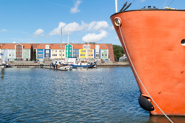 Bow of lightship and wharf houses in the harbour of Hellevoetsluis, Netherlands