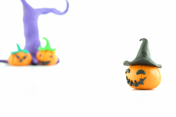Halloween pumpkin made of clay over white background