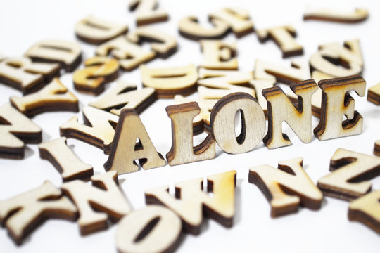 "Alone" written in wooden letters