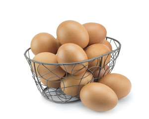 Stack of Fresh eggs in curved steel basket isolated on white background.