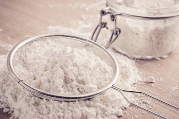 Flour in sieve and glass jar, filtered image
