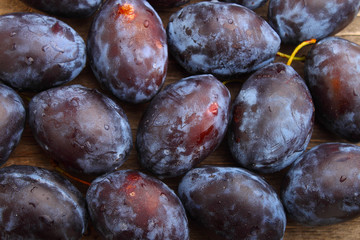 purple plums on a wood background