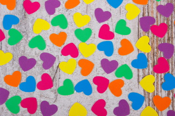 Colorful hearts of paper for valentines on old wooden background