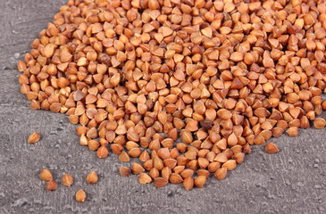 Heap of buckwheat groats on cement structure