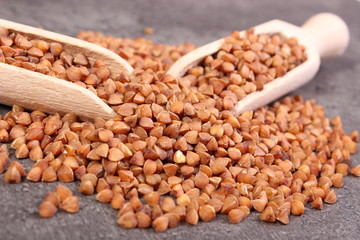 Buckwheat groats with spoon on cement structure