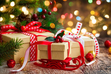 Christmas presents  and festive decor over wooden background