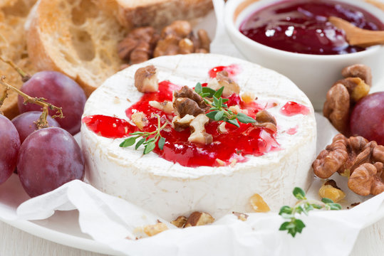 camembert with berry jam and toasts, close-up