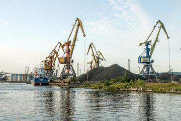 Fototapeta na wymiar Many port cranes and other machinery