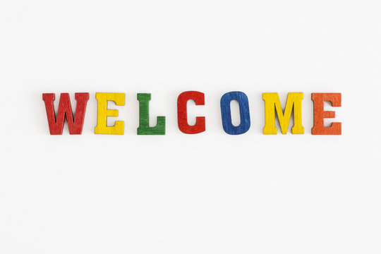 Series "Welcome": word Welcome in wooden letters on white background
