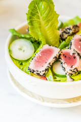Grilled tuna salad in white bowl - healthy food
