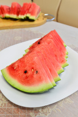 slices of watermelon on a plate at the table