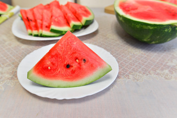 slices of watermelon on a plate at the table