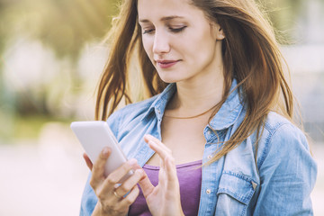 Woman beautiful model with a phone on the street