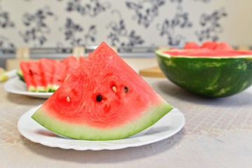 slices of watermelon on a plate at the table