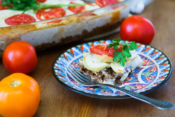 Moussaka dinner on painted plate, close view