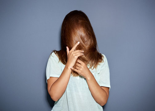 Fun Portrait Of A Woman Hiding Behind Her Hair