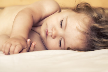 Obraz na płótnie Canvas Sleeping baby in bed