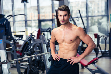 Fototapeta na wymiar Handsome fitness man standing at gym