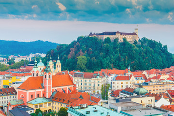 Fototapeta na wymiar Aerial view of Ljubljana city with castle on hill, beautiful buildings and church in summertime, Slovenia