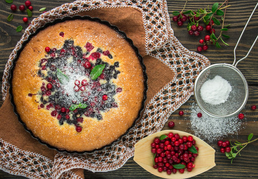 Sponge cake with berries - cranberries and blueberries.  Rustic style