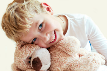 Cute little boy hugs his teddy bear. The manifestation of feelin