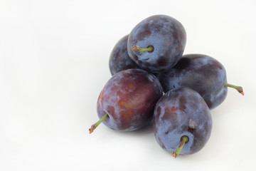 Closeup of ripe plums isolated on white.