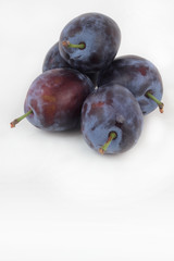 Closeup of ripe plums isolated on white.