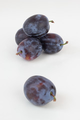 Closeup of ripe plums isolated on white.