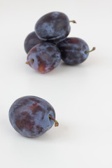 Closeup of ripe plums isolated on white.