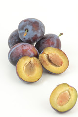 Closeup of ripe plums isolated on white.
