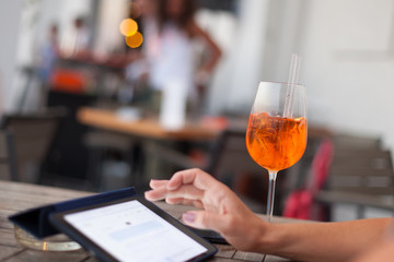 cocktail and tablet in coffee shop