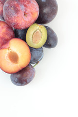 Naklejka na ściany i meble Closeup of ripe plums isolated on white.