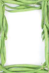 Bunch of fresh green beans formed in a frame, isolated on white.