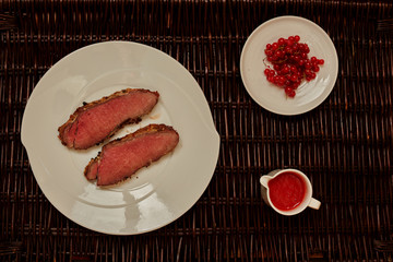 Two fried steak lie on a large white plate