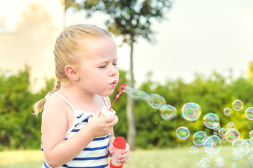 Sympathetically playing girl and her soap bubbles