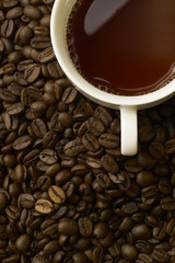 Coffee cup and coffee beans on table