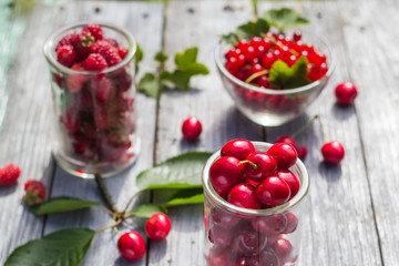 Freshly picked cherries raspberry fruits table