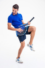 Full length portrait of a male tennis player having fun