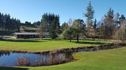 Magnificent tranquil New Zealand landscape with river, trees and lawns in Ohakune